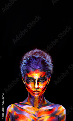 Portrait of the bright beautiful girl with art colorful make-up and bodyart