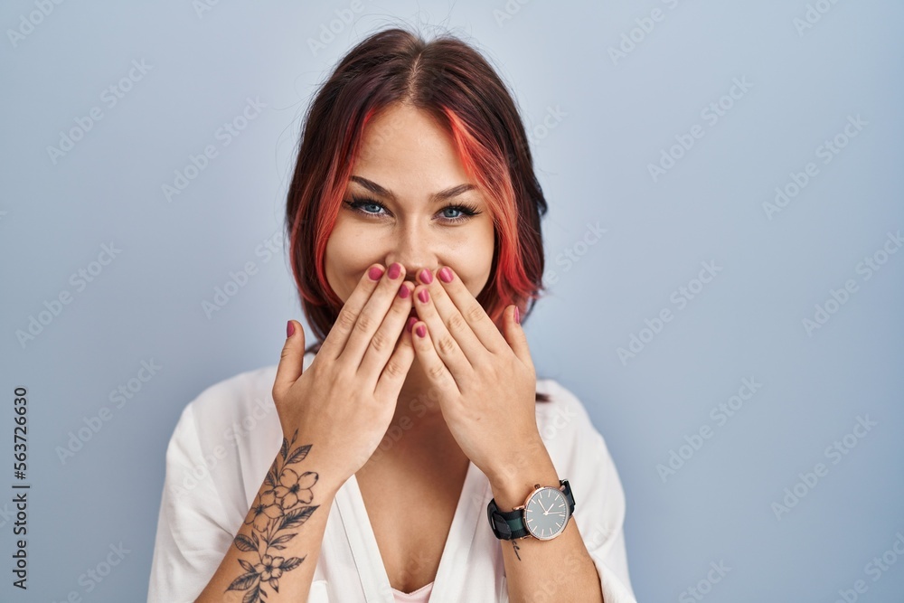 Young caucasian woman wearing casual white shirt over isolated background laughing and embarrassed giggle covering mouth with hands, gossip and scandal concept Young caucasian woman wearing casual white shirt over isolated background laughing and embarrassed giggle covering mouth with hands, gossip and scandal concept
