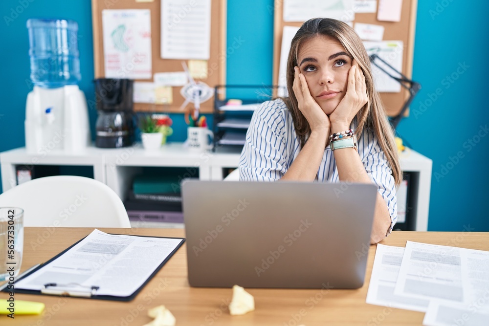 Young beautiful hispanic woman business worker tired using laptop at street Young beautiful hispanic woman business worker tired using laptop at street