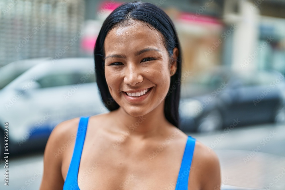 Young beautiful latin woman smiling confident standing at street