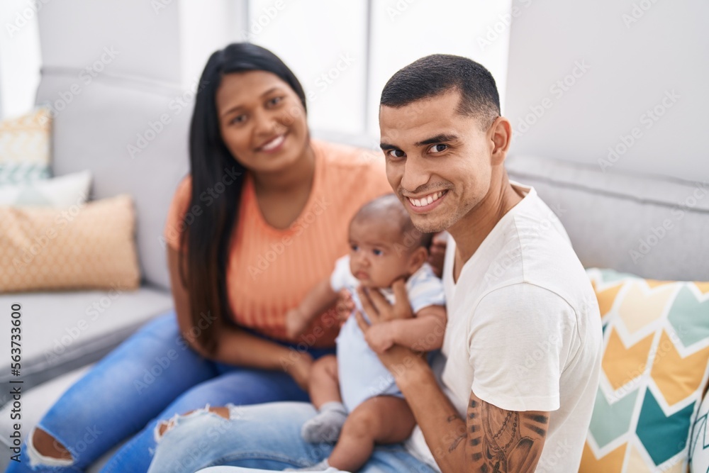 Hispanic family smiling confident sitting on sofa at home