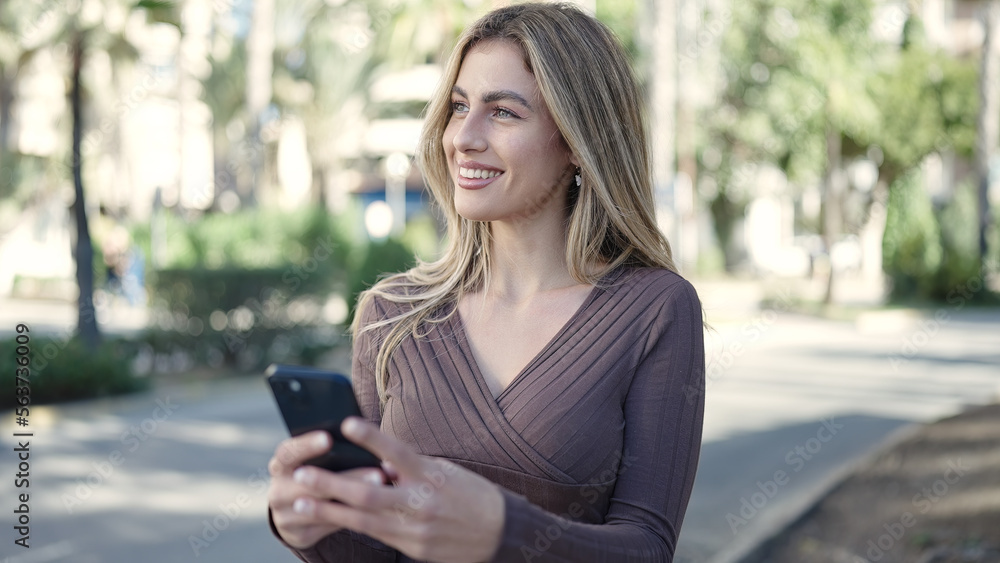 Young blonde woman smiling confident using smartphone at park Young blonde woman smiling confident using smartphone at park