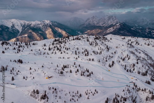 Aerial drone panorama of Zoncolan ski resort in northern Italy on a cloudy winter day. Visible mountains around, good visibility. photo