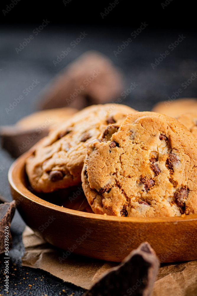 Fototapeta premium Homemade cookies with chocolate. Against a dark background