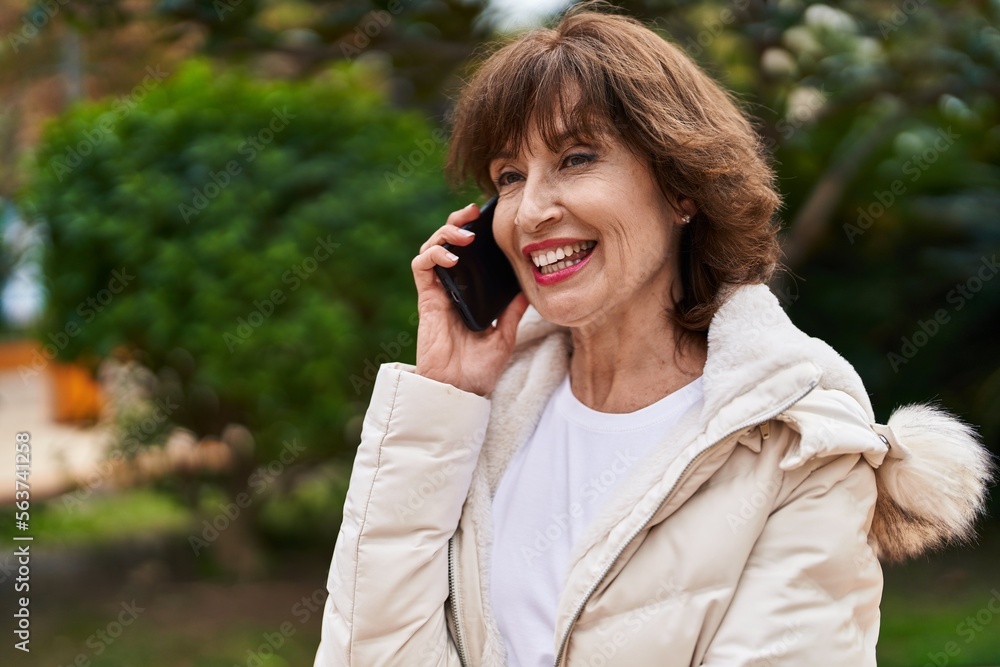 Middle age woman smiling confident talking on the smartphone at park Middle age woman smiling confident talking on the smartphone at park