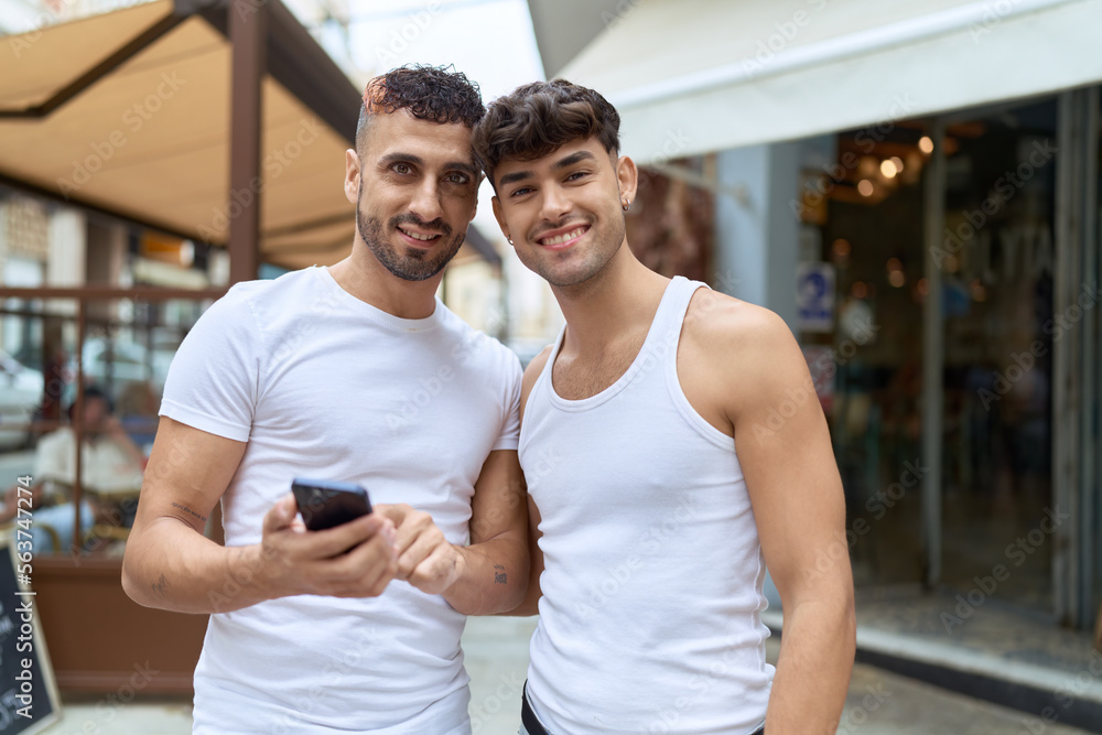 Two hispanic men couple smiling confident using smartphone at coffee shop terrace Two hispanic men couple smiling confident using smartphone at coffee shop terrace
