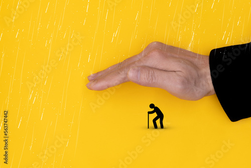 Welfare for the Elderly. Concept of protecting the elderly icon by hand from heavy rain.