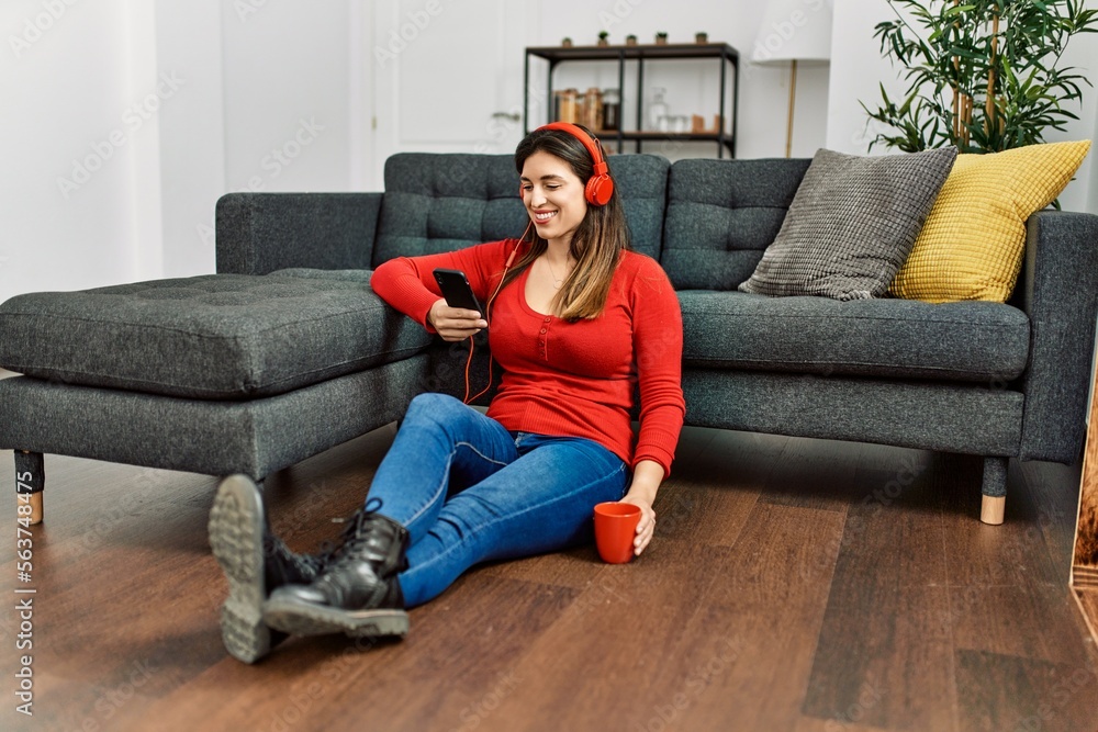 Young woman using smartphone and drinking coffee at home Young woman using smartphone and drinking coffee at home