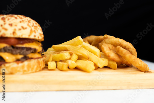 Burger cheese with potato in wooden table and black backgournd  photo