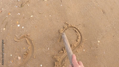 Video hand with stick writing I love you in the sand. Love emotion. 4K video. With sound.