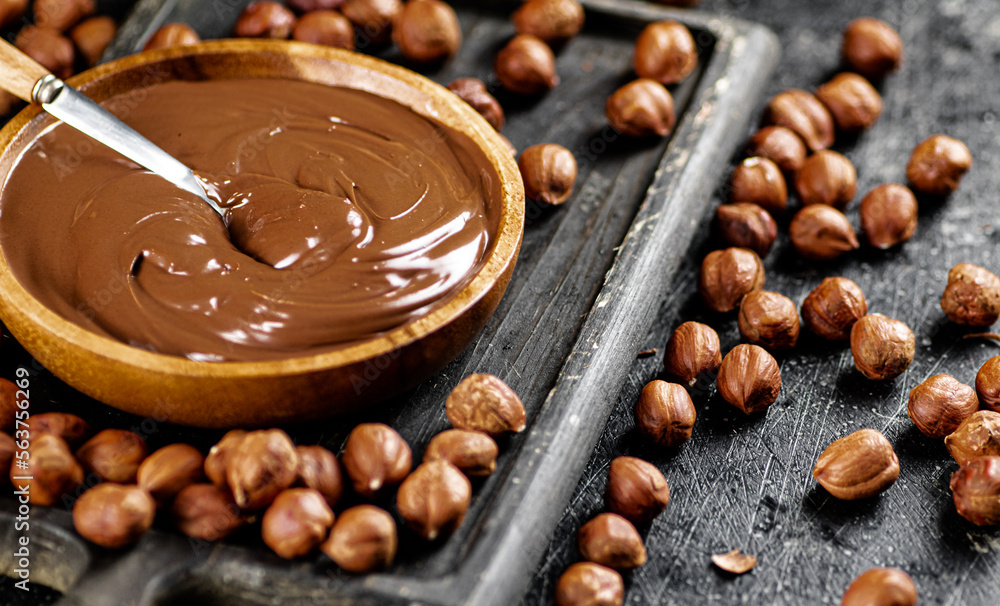 Hazelnut butter on a cutting board with a spoon. Hazelnut butter on a cutting board with a spoon.