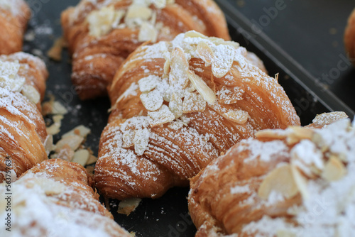Almond Croissant pastry Bakery homemade. Traditional French breakfast tray with gold and crispy croissants.