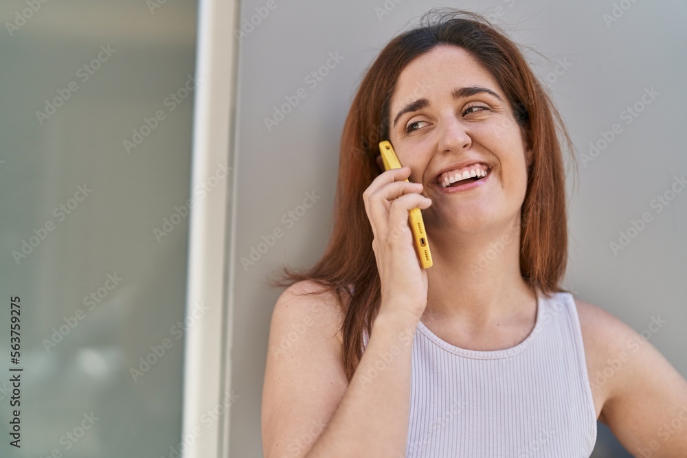 Young woman smiling confident talking on the smartphone at street Young woman smiling confident talking on the smartphone at street