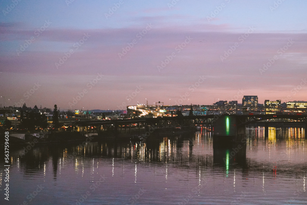 Reflection of city in river in downtown Portland Oregon at sunset. 