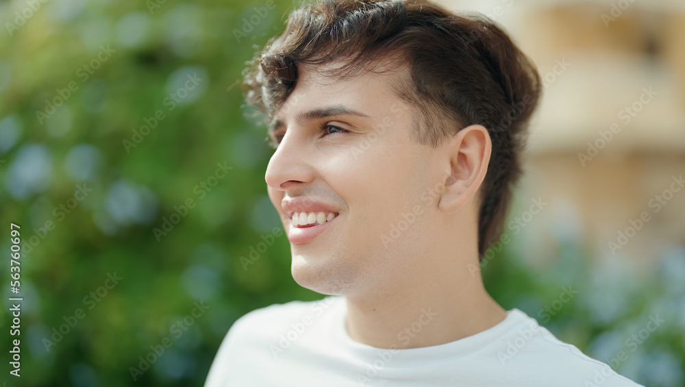 Non binary man smiling confident looking to the side at park Non binary man smiling confident looking to the side at park