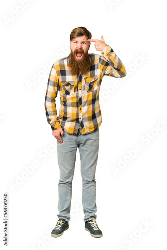 Young adult redhead man with a long beard standing full body isolated showing a disappointment gesture with forefinger.