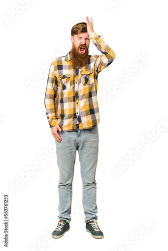 Young adult redhead man with a long beard standing full body isolated forgetting something, slapping forehead with palm and closing eyes.