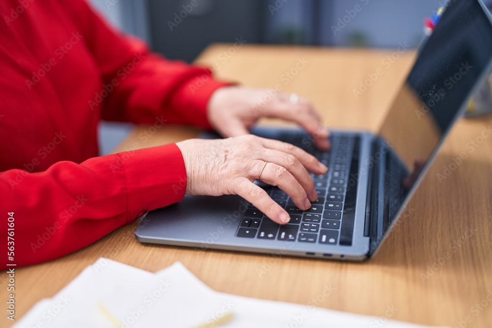 Senior woman business worker using laptop working at office Senior woman business worker using laptop working at office