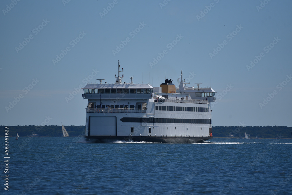 Ferry boat transporting passengers and cars in the summer