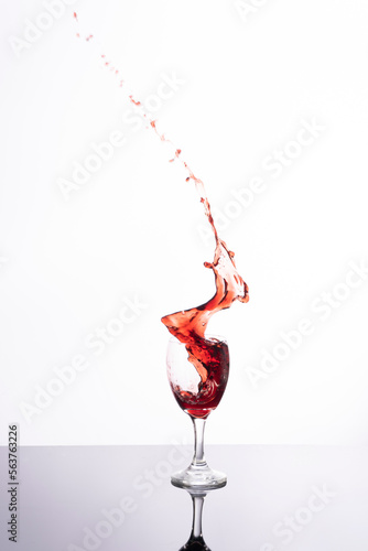 Explosion of wines in a glass, with a white background and in studio