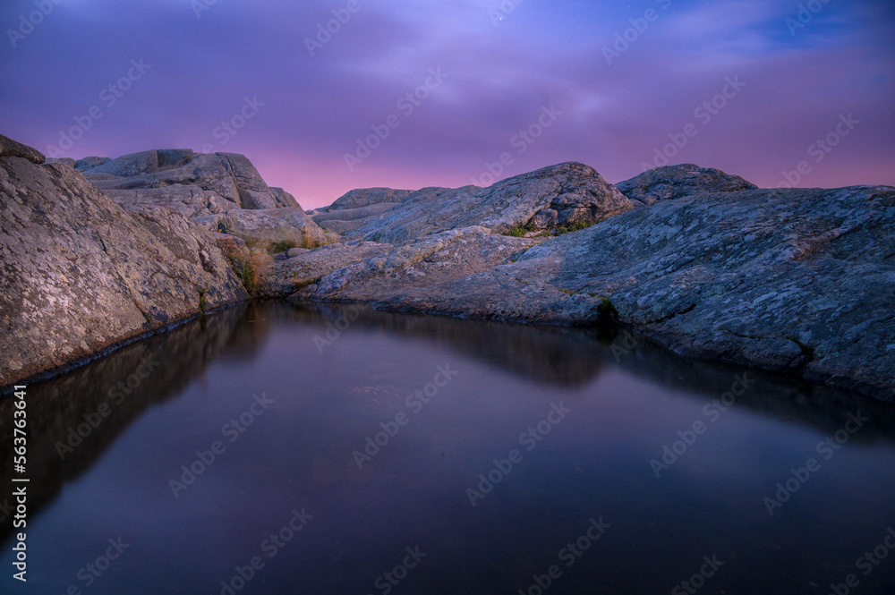 A small reflecting puddle at the summit of Mount Monadnock at sunrise