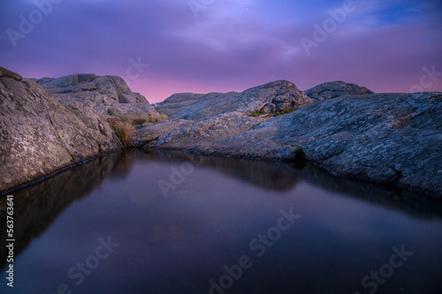 A small reflecting puddle at the summit of Mount Monadnock at sunrise