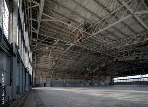 Abandoned airplane hanger with large, steel rafters and trusses	
