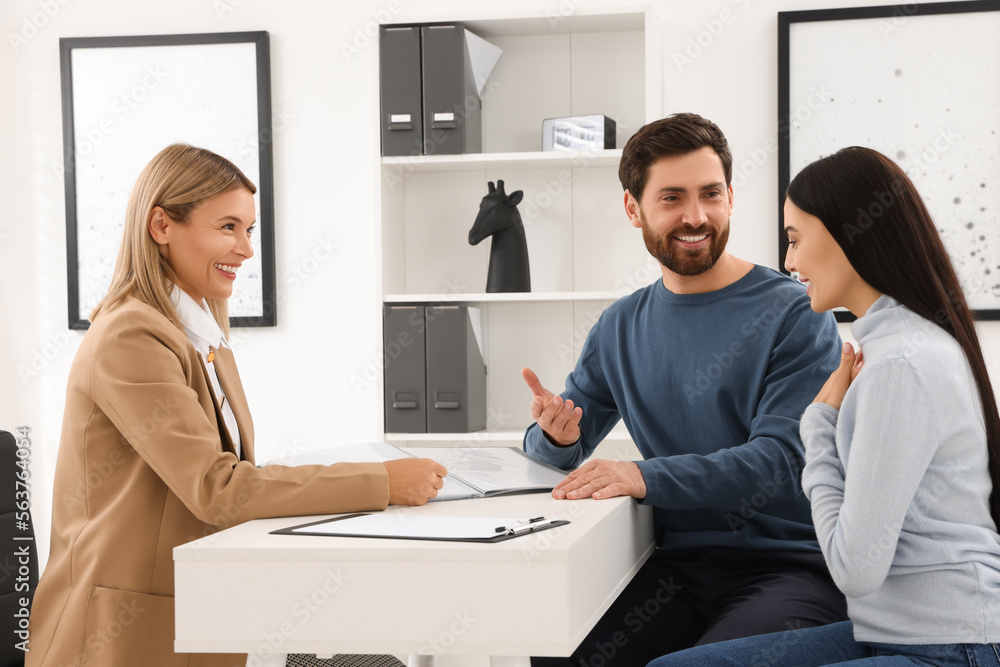 Fototapeta premium Real estate agent working with couple in office