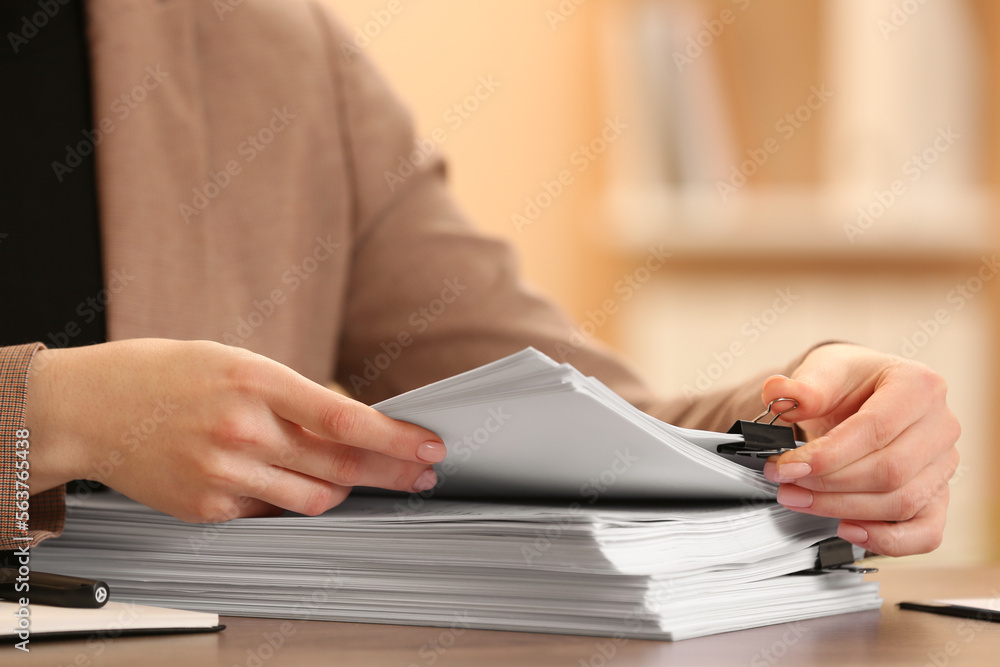 Woman working with documents at table in office, closeup Woman working with documents at table in office, closeup