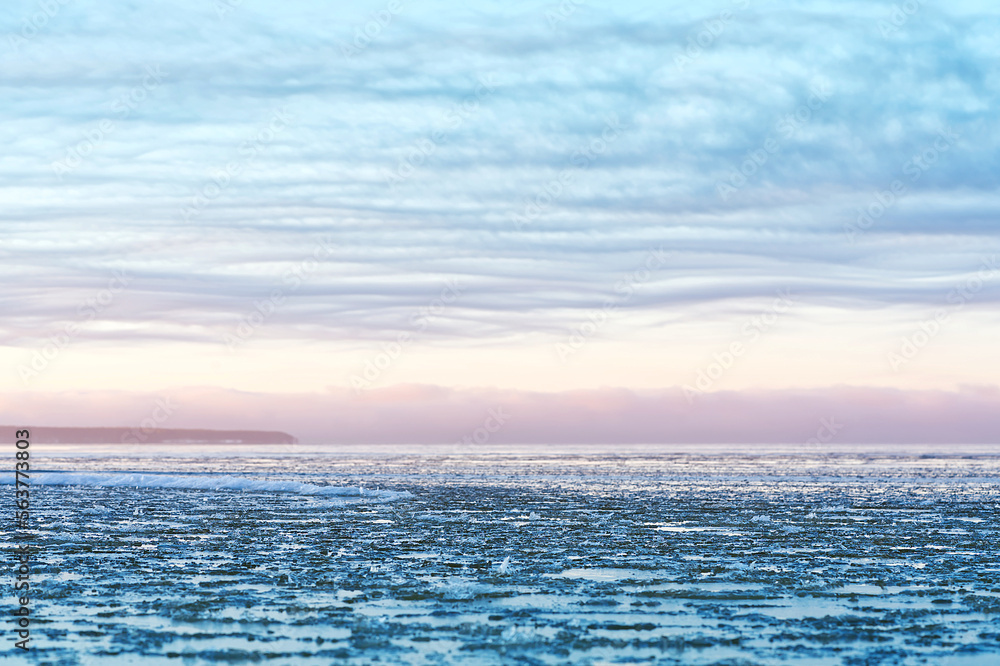 Panoramic view of the shore of the Baltic sea at sunset in winter. Ice fragments in sea close-up. Colorful seacape, soft sunlight. winter sea. The coast of the Gulf of Finland in winter