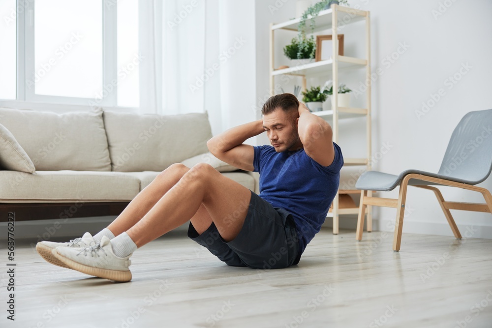 Man sportsman training at home, push-up exercises for arm, leg and back muscles, strong body and correct posture, the concept of health and beauty Man sportsman training at home, push-up exercises for arm, leg and back muscles, strong body and correct posture, the concept of health and beauty