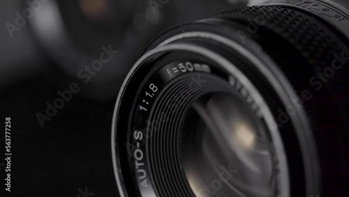 Detail of an old photographic camera with light reflections. Film roll camera.