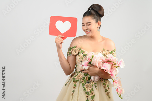 Asian beautiful bride smiling and posing with heart sign on white background