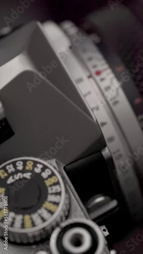 Detail of an old photographic camera with light reflections. Film roll camera.