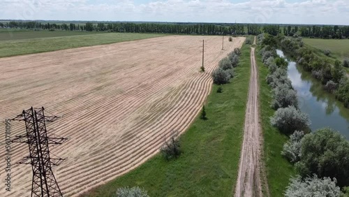 Green and yellow fields, road, river, dam. Aerial video. High quality FullHD footage