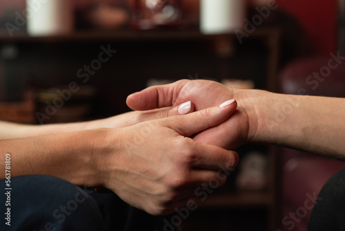 The therapist holds the hands of his patient during therapy. The concept of psychological assistance © Aleksandr Rybalko