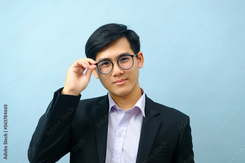 Portrait of businessman standing and looking at camera. Portrait of businessman standing and looking at camera.
