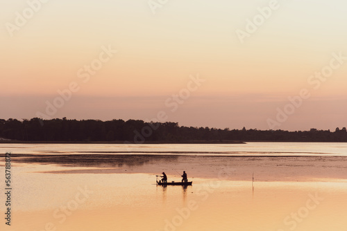 Fisherman's boat on the river with sunset. © JP