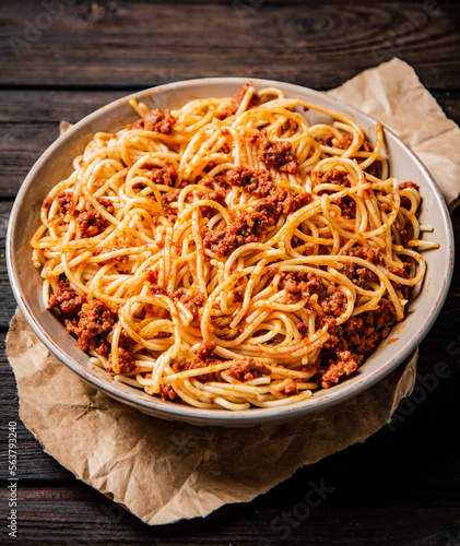 A full plate of spaghetti bolognese on the table. 