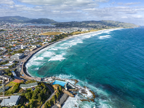 Beautiful high angle aerial drone view of a hot salt water pool in St Clair, a beachside suburb of Dunedin, the second-largest city in the South Island of New Zealand. Dunedin city in the background.
