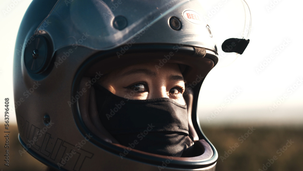 Young woman wearing motorcycle helmet Young woman wearing motorcycle helmet