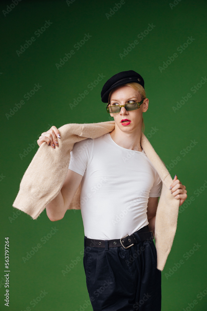Studio photo of a man with make up isolated on green background