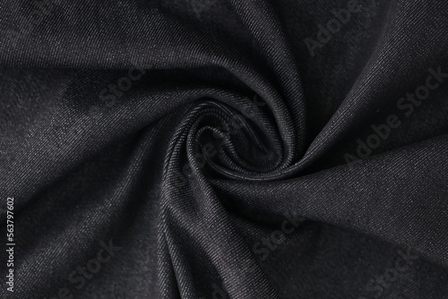 Swirled gray denim fabric as background.