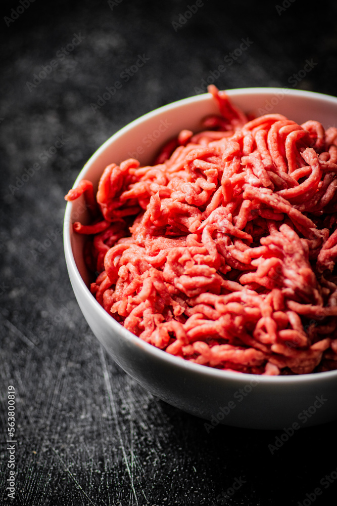 Bowl on the table with fresh minced meat. Bowl on the table with fresh minced meat.