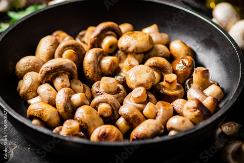 Homemade fried mushrooms in a frying pan. 
