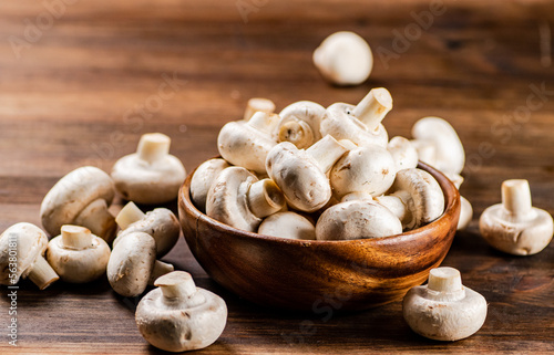 A wooden plate full of fresh mushrooms. 