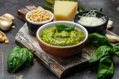 Green basil pesto with italian recipe ingredients, Basil, olive oil, parmesan, garlic, pine nuts. banner, menu, recipe place for text, top view