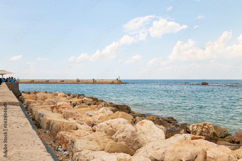 Fototapeta premium Promenade in the old town of Yafo and the skyscrapers of Tel Aviv in the distance, in Tel Aviv - Yafo city, Israel