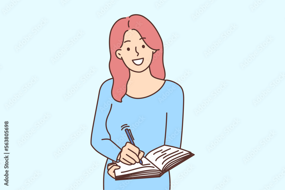Smiling woman writing in notebook Smiling woman writing in notebook
