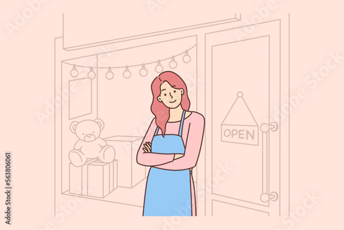 Smiling female shop owner near store